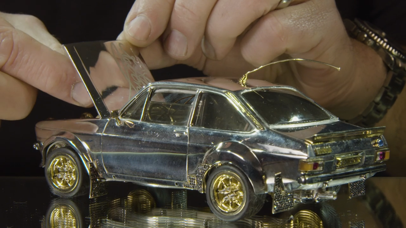 Illustration for article titled I Am So Here for This Tiny Ford Escort Model Made of $90,000 in Silver, Gold and Diamonds